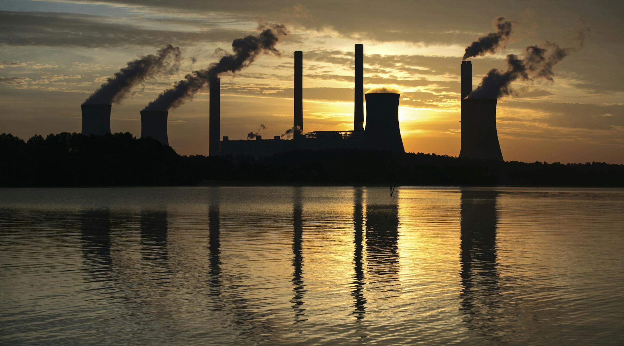 The coal-fired Plant Scherer, one of the nation's top carbon dioxide emitters, stands in the distance in Juliette, Ga., Saturday, June, 3, 2017. U.S. President Donald Trump declared Thursday he was pulling the U.S. from the landmark Paris climate agreement, striking a major blow to worldwide efforts to combat global warming and distancing the country from its closest allies abroad. (AP Photo/Branden Camp)