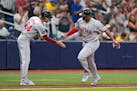 Red Sox star Rafael Devers celebrates with third base coach Kyle Hudson (84) after his two-run homer off Rays starting pitcher Taj Bradley during the 