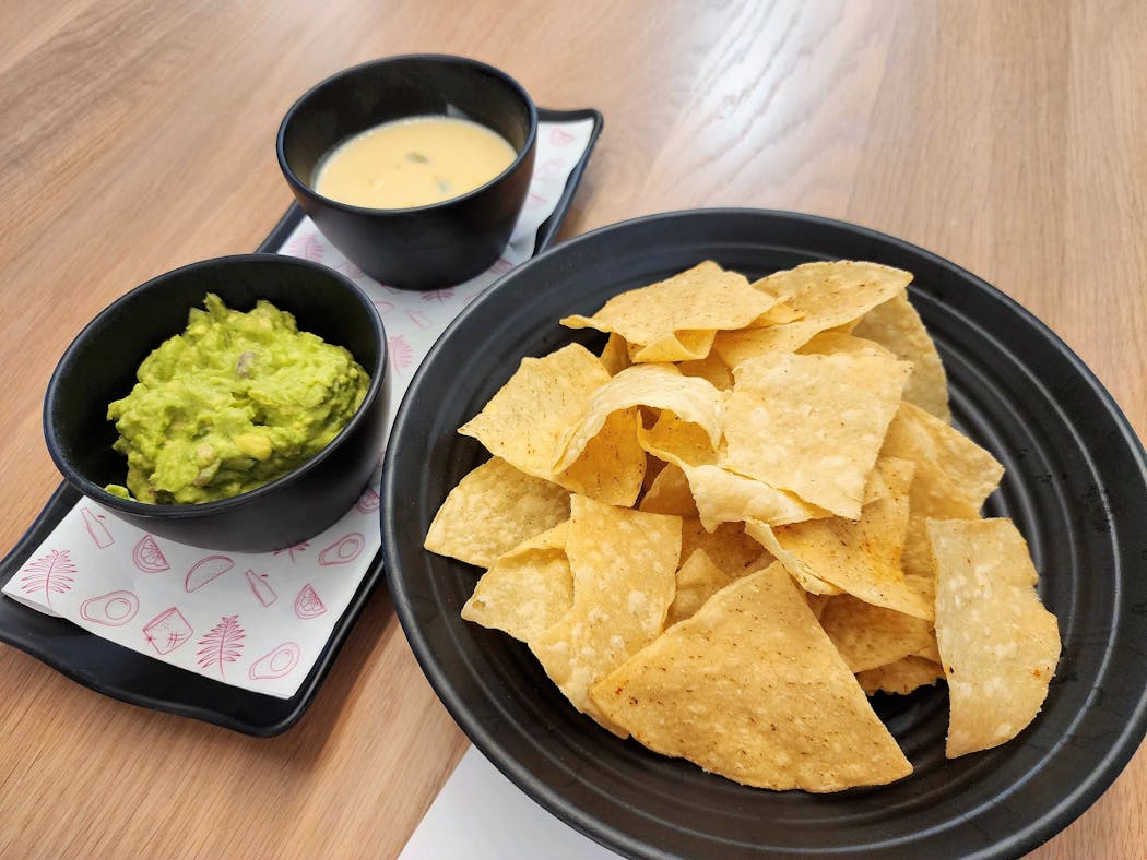 Chips are dusted with chile and lime and served with guacamole and queso at Puralima Cantina in Minneapolis.