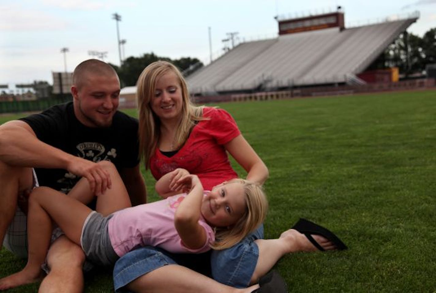 Tyler Johnson is a football player at the University of Minnesota, an Iraq Vet and a father and husband. He posed for a picture on campus with his wife Danielle and daughter Anika.