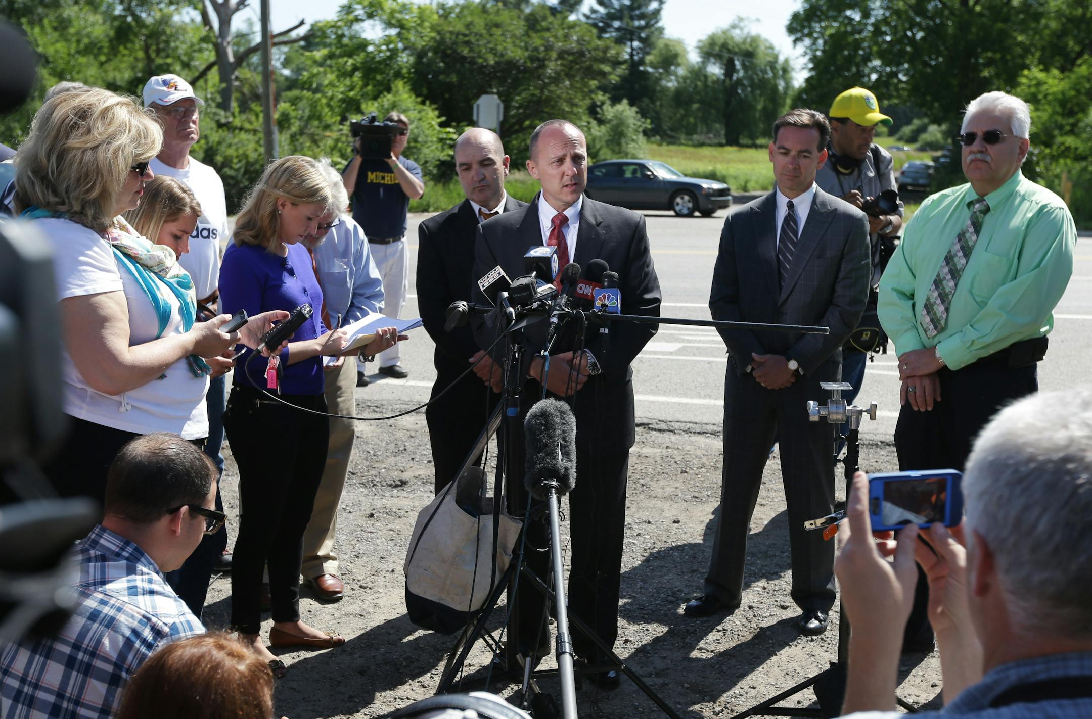 Robert Foley, center, special agent in charge of the FBI's Detroit division, addresses the media in Oakland Township, Mich., Wednesday, June 19, 2013 where he announced the FBI was ending the search operations for the remains of Teamsters union president Jimmy Hoffa who disappeared from a Detroit-area restaurant in 1975.