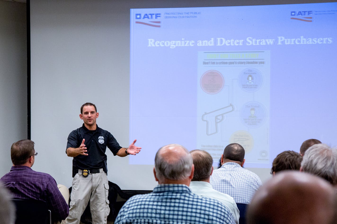 ATF Special Agent Nic Garlie speaks about straw purchasers during the Federal Firearms License Educational Seminar at the Hennepin County Library in Edina. ] COURTNEY PEDROZA &#x2022; courtney.pedroza@startribune.com; Federal Firearms License Educational Seminar for gun store owners to protect against crimes like straw purchasing; Hennepin County Library in Edina; July 27, 2017; K9 Brock; explosive detection K9 including firearms, shell casing, and ammo