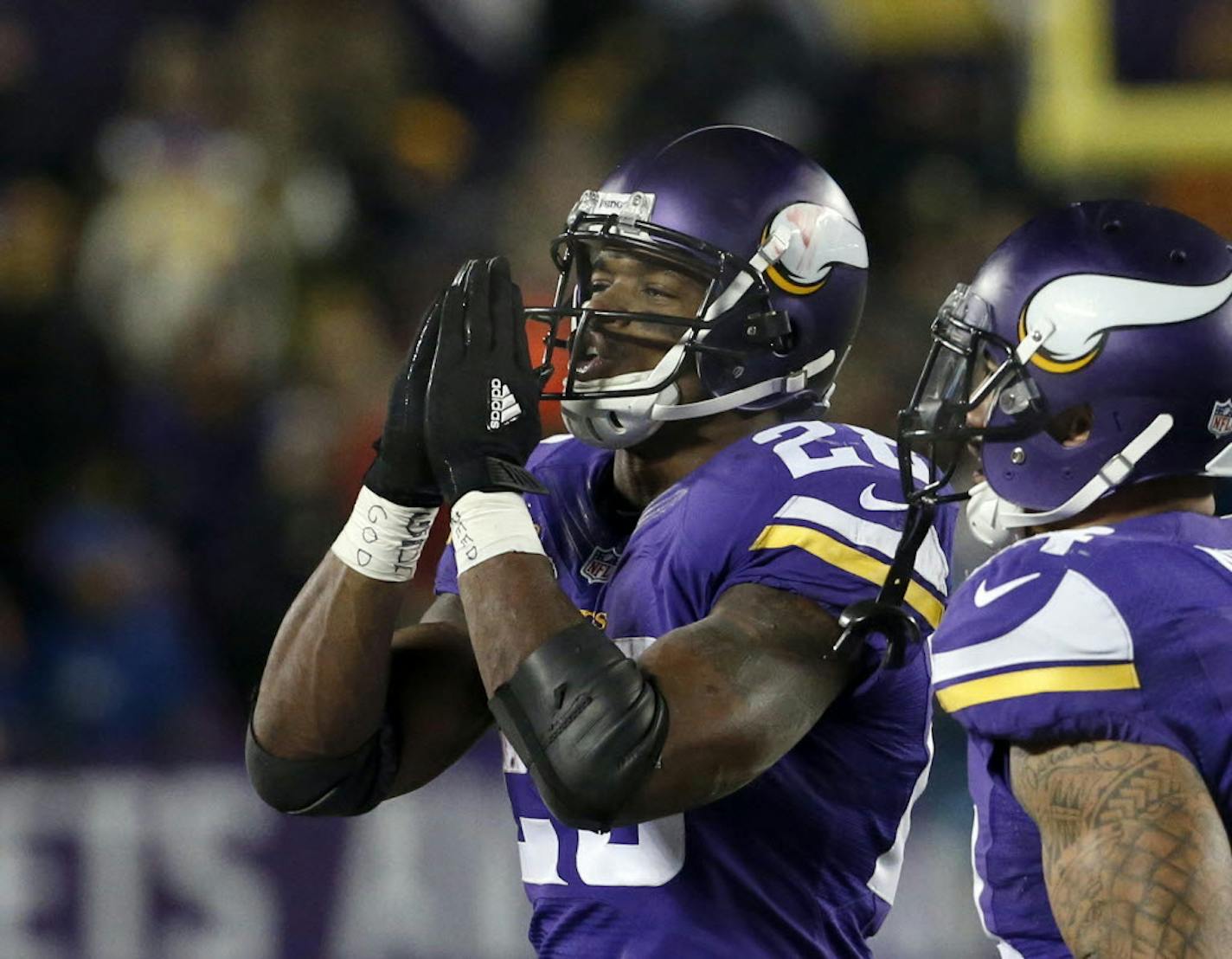 Minnesota Vikings running back Adrian Peterson, left, gestures after his touchdown during the second half of an NFL football game against the New York Giants, Sunday, Dec. 27, 2015, in Minneapolis.