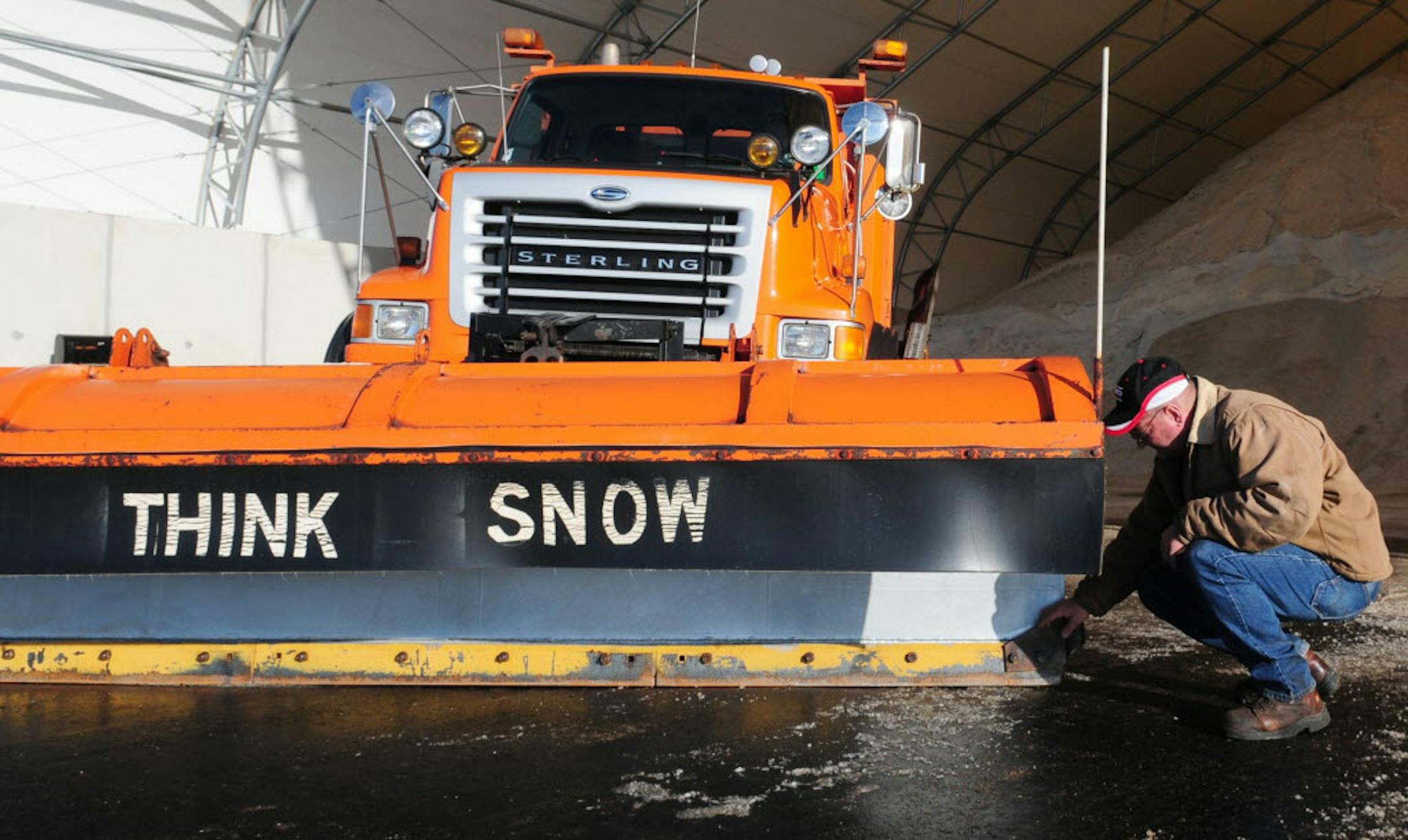Dick Bordwell, transportation generalist senior, examined the cutting blades on a snow plow near the salt shed at the MNDOT facility in Baxter, Minn.
