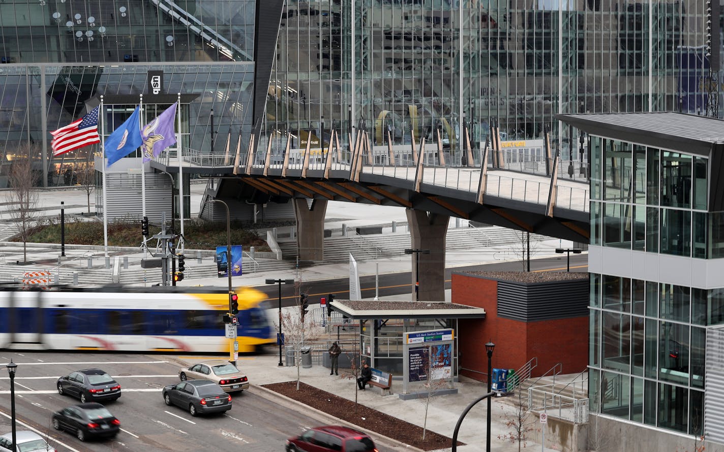 A METRO green line passes underneath the pedestrian bridge to U.S. Bank Stadium Tuesday afternoon. ] ANTHONY SOUFFLE &#x2022; anthony.souffle@startribune.com Pictured is the pedestrian bridge to U.S. Bank Stadium seen Nov. 29, 2016 in Minneapolis. The $9.6 million pedestrian bridge went over budget due to problems with the elevator, and now the Metropolitan Council must make up the difference of about $60,000.