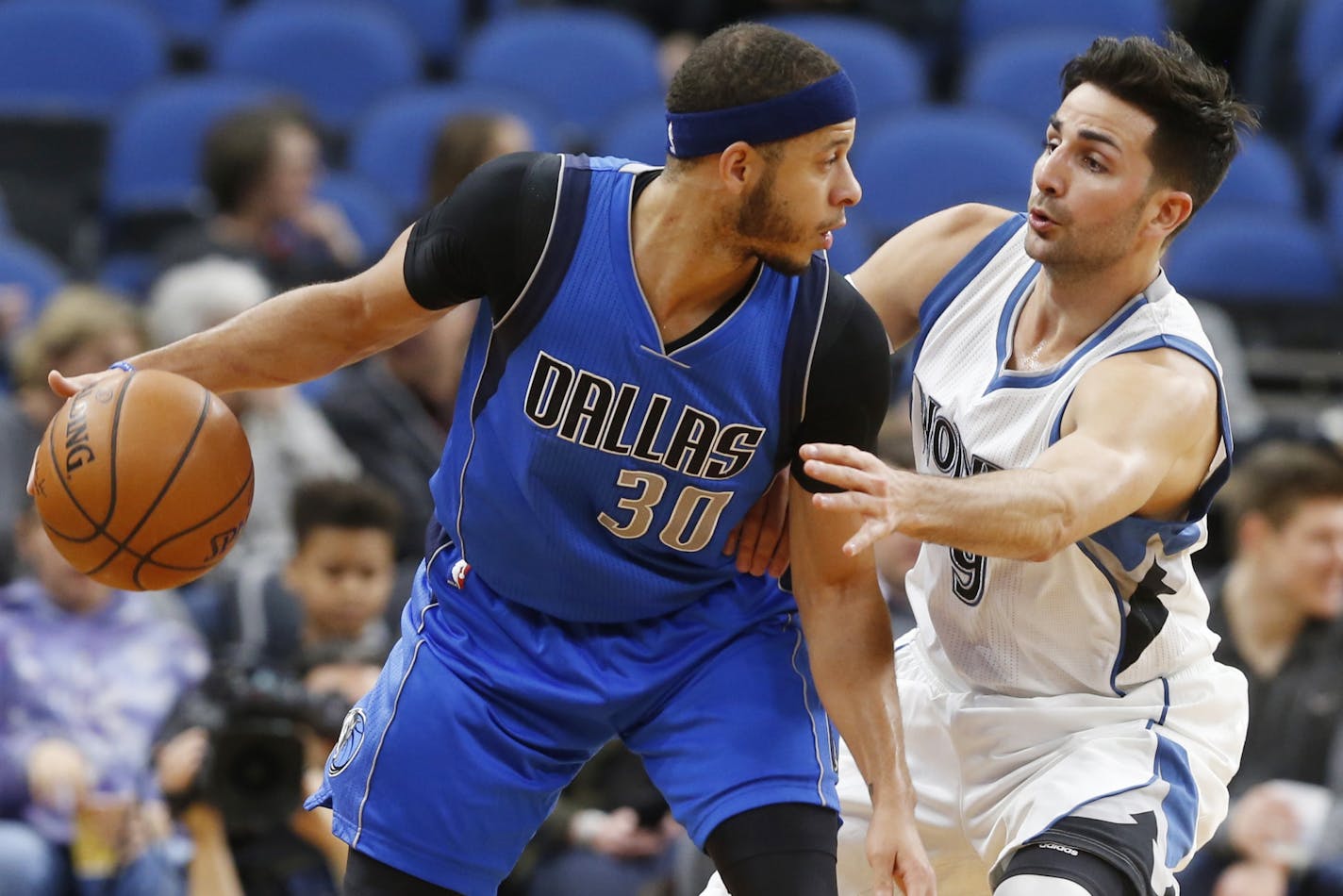 Dallas Mavericks' Seth Curry, left, keeps the ball at a safe distance from Minnesota Timberwolves' Ricky Rubio, of Spain, during the first half of an NBA basketball game Friday, Feb. 24, 2017, in Minneapolis.