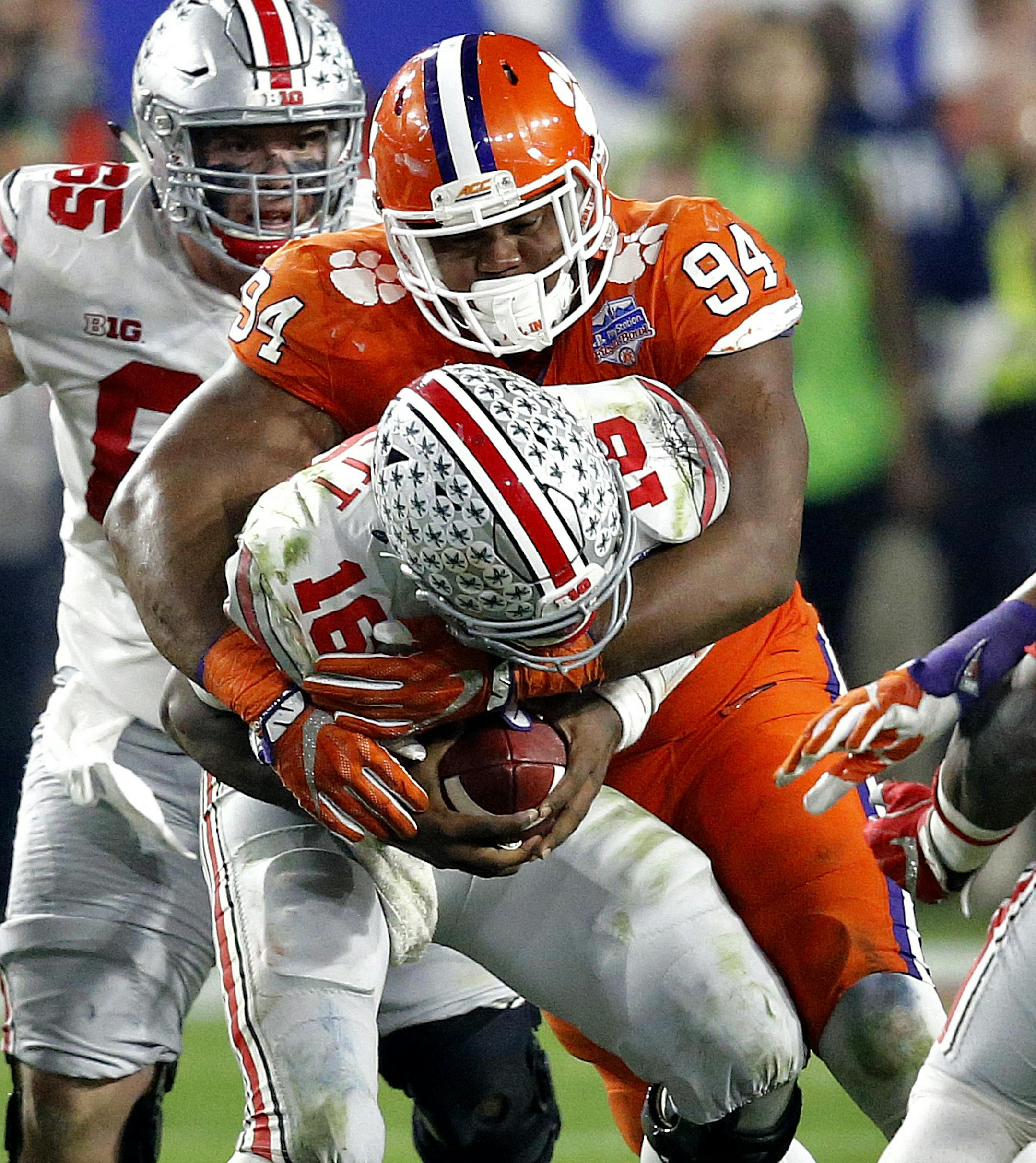 Clemson defensive tackle Carlos Watkins (94) sacks Ohio State quarterback J.T. Barrett (16) during the second half of the Fiesta Bowl NCAA college football playoff semifinal, Saturday, Dec. 31, 2016, in Glendale, Ariz. (AP Photo/Ross D. Franklin)