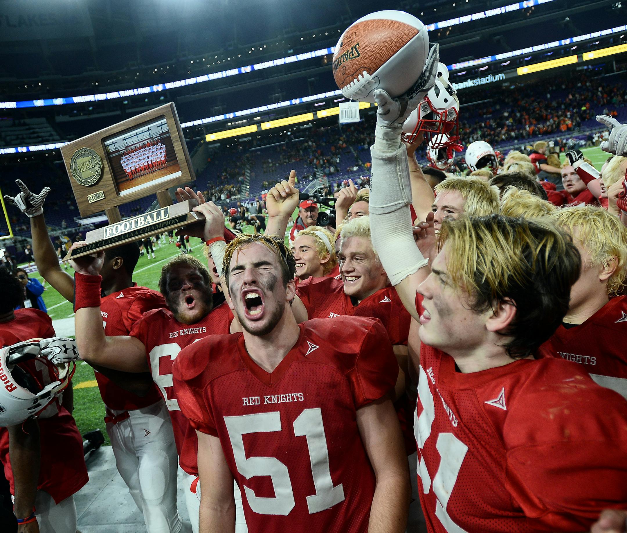 Benilde-St. Margaret's School players, including Benilde-St. Margaret's offensive lineman John Whitmore (51) celebrated with their 4A trophy after defeating Winona in the 4A championship game Friday night. ] (AARON LAVINSKY/STAR TRIBUNE) aaron.lavinsky@startribune.com Winona played Benilde-St. Margaret's in the Class 4A Championship Game of the the Prep Bowl on Friday, Nov. 25, 2016 at U.S. Bank Stadium in Minneapolis, Minn.