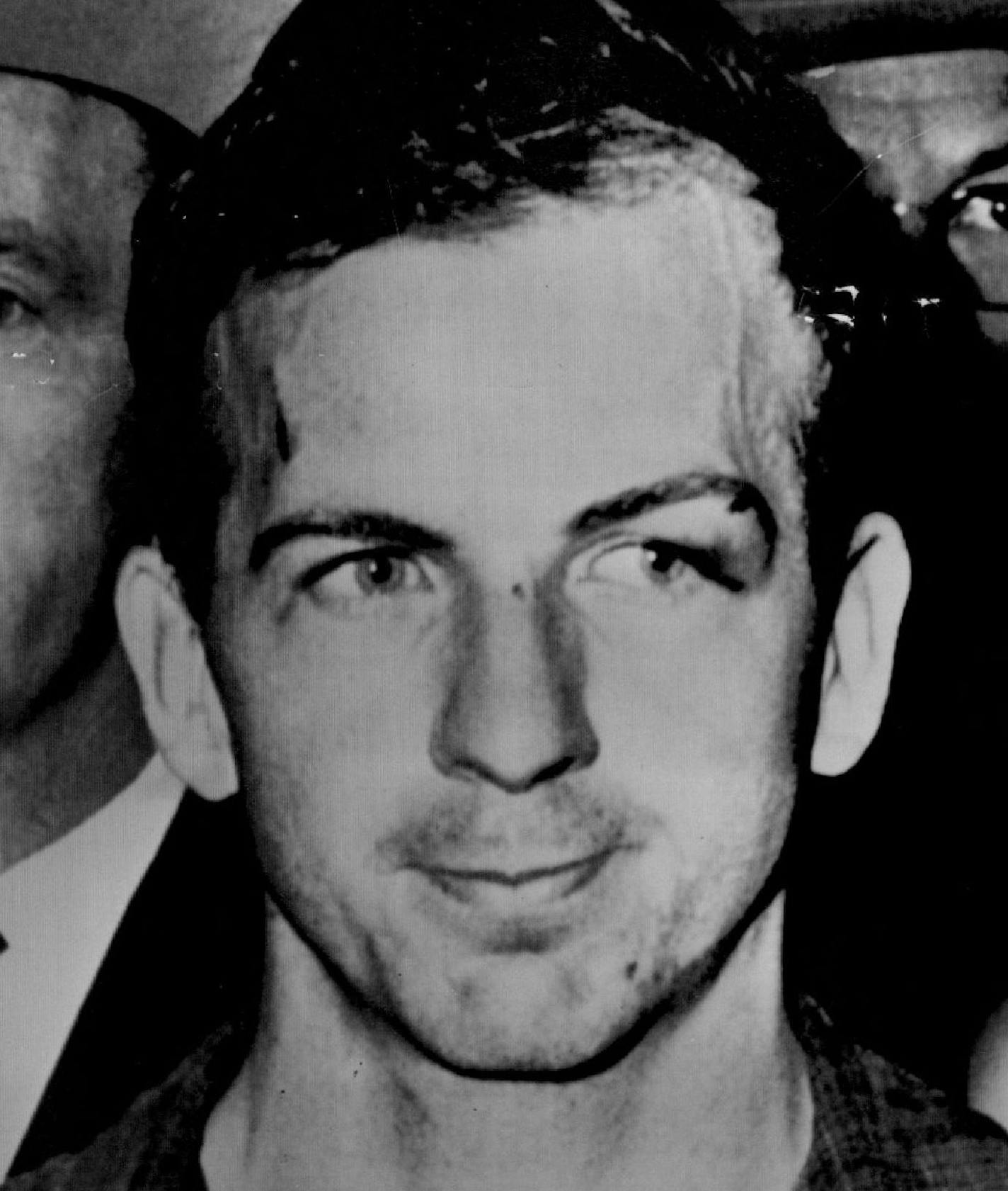 November 23, 1963 Suspected Assassin Lee Harvey Oswald At police headquarters in Dallas Lee Har&#xac;&#x2260;vey Oswald, 24, a pro-Castro Marxist, who once sought Russian citizenship, was jailed Friday as the prime suspect in the assassination of President Kennedy. Oswald, a former U.S. Marine, was charged with slaying a policeman shortly after Mr. Kennedy was shot at 12:31 p.m. Minneapolis time in a Dallas motorcade. Oswald worked in the building from which the shots were fired, and where a rif