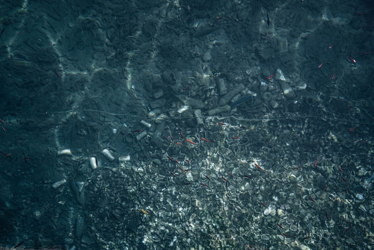 Trash seen at the bottom of the sea at the port of Kithnos in Athens. MUST CREDIT: Photo by Alice Martins for The Washington Post.