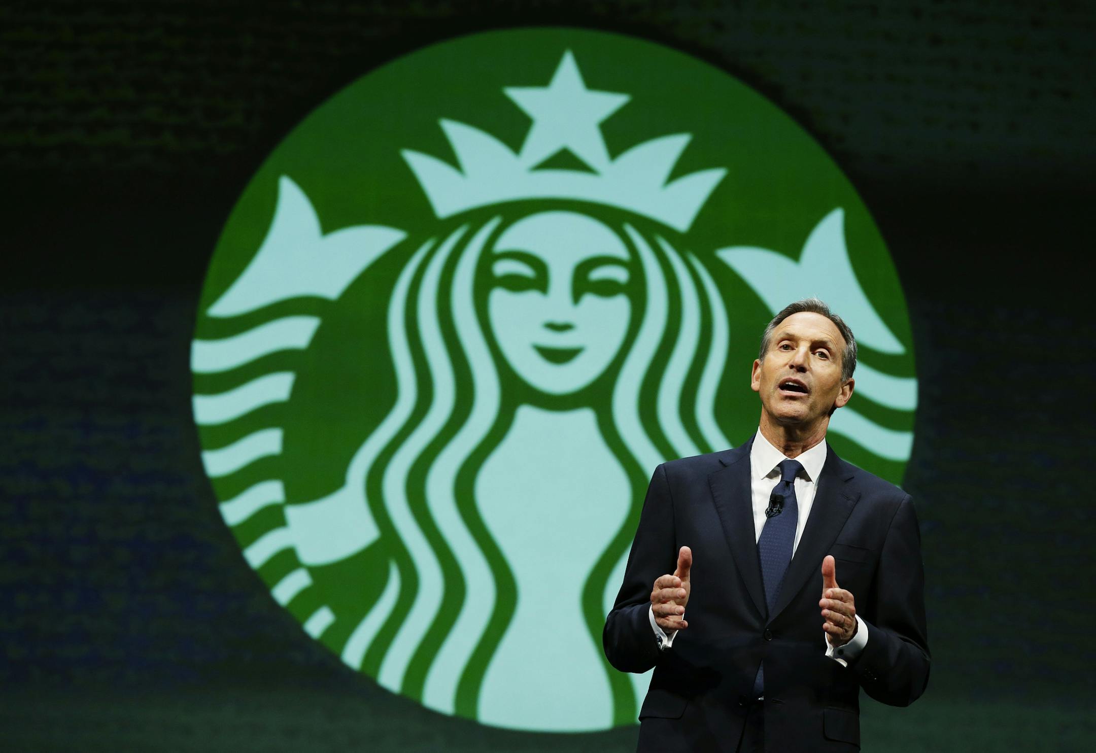 FILE- In this March 19, 2014, file photo, Howard Schultz, chairman and CEO of Starbucks Coffee Company, speaks at the company's annual shareholders meeting in Seattle. Starbucks Corp. says Howard Schultz is stepping down executive chairman later this month. Schultz, who oversaw the transformation of Starbucks into a global chain with more than 28,000 locations, had retired as CEO last year to focus on innovation and social impact projects as executive chairman. (AP Photo/Ted S. Warren, File)