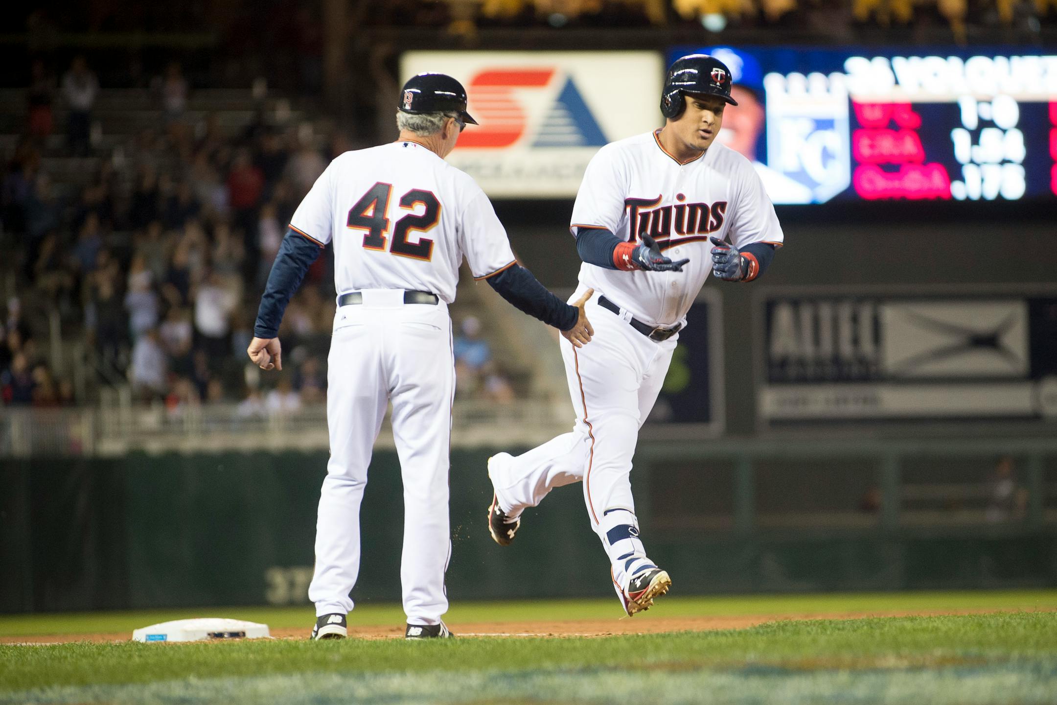Minnesota Twins left fielder Oswaldo Arcia high fives third base coach Gene Glynn while round the bases after hitting a two-run homer in the bottom of the fourth against the Kansas City Royals. ] (Aaron Lavinsky | StarTribune) aaron.lavinsky@startribune.com The Minnesota Twins play the Kansas City Royals on Wednesday, April 15, 2015 at Target Field.