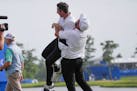 Shane Lowry, of Ireland, hoists up teammate Rory McIlroy, of Northern Ireland, after they won the PGA Zurich Classic golf tournament at TPC Louisiana 