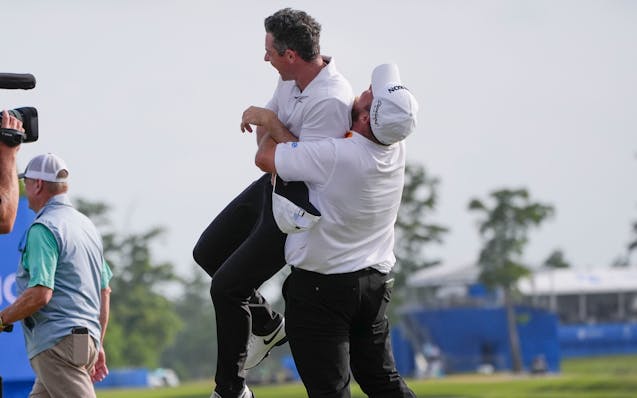 Shane Lowry, of Ireland, hoists up teammate Rory McIlroy, of Northern Ireland, after they won the PGA Zurich Classic golf tournament at TPC Louisiana 