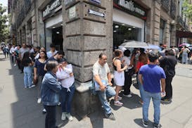 Voters line up around the block as they wait to cast their ballots, during general elections in Mexico City, Sunday, June 2.