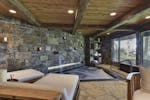 A cozy stone and timber grotto with a hot tub that can seat up to 10 people inside a 11,193 square foot Tonka Bay home for sale for $5.25 million.