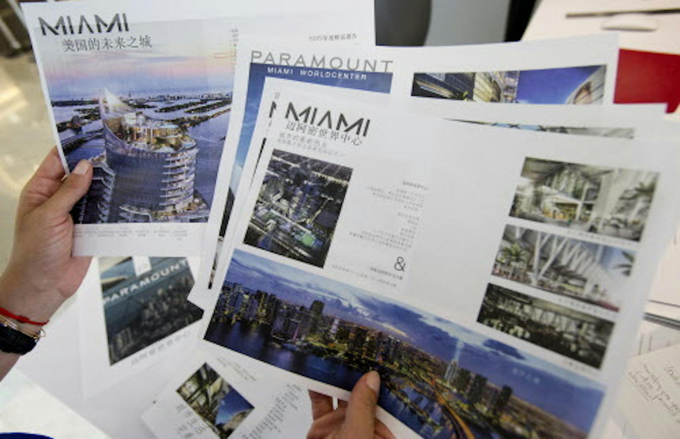 Peggy Fucci, CEO of OneWorld Properties, holds brochures written in Chinese for the Paramount Miami Worldcenter, in Fort Lauderdale, Fla. A nearly 40 percent plunge in the Shanghai stock market since mid-June has sent Chinese investors looking for safer investments. Some are focusing on U.S. real estate, including the condos Fucciís real estate brokerage sells in Miami. Sheís sold six condos to Chinese buyers in the past month, twice the number sheís typically sold. (AP Photo/Wilf
