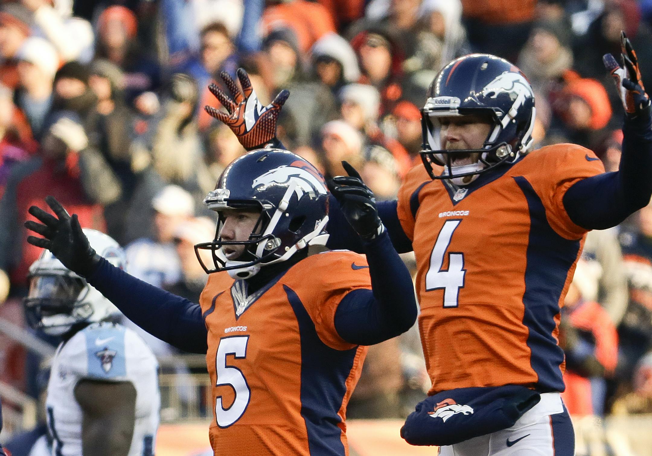 Denver Broncos kicker Matt Prater, left, celebrates a 64-yard field goal with Britton Colquitt during the first half of an NFL football game against the Tennessee Titans during the first half of an NFL football game on Sunday, Dec. 8, 2013, in Denver. (AP Photo/Jack Dempsey)