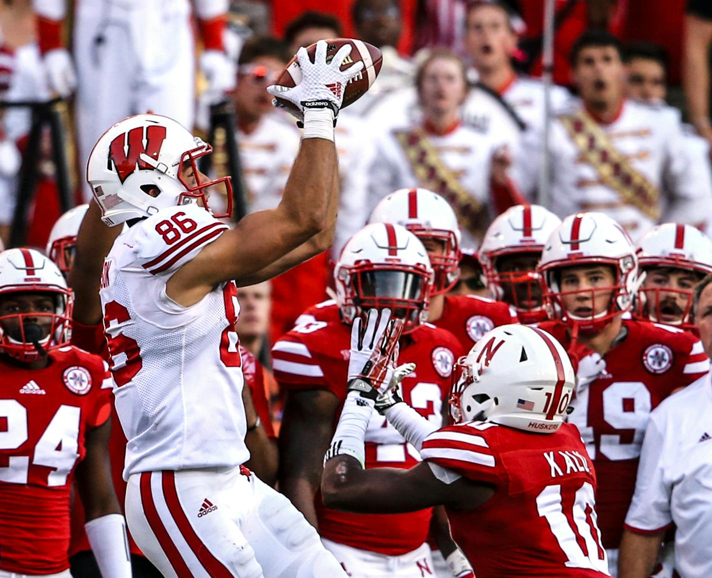 Wisconsin wide receiver Alex Erickson (86) makes a catch over Nebraska cornerback Joshua Kalu (10) during the second half of an NCAA college football game in Lincoln, Neb., Saturday, Oct. 10, 2015. Wisconsin won 23-21. (AP Photo/Nati Harnik)