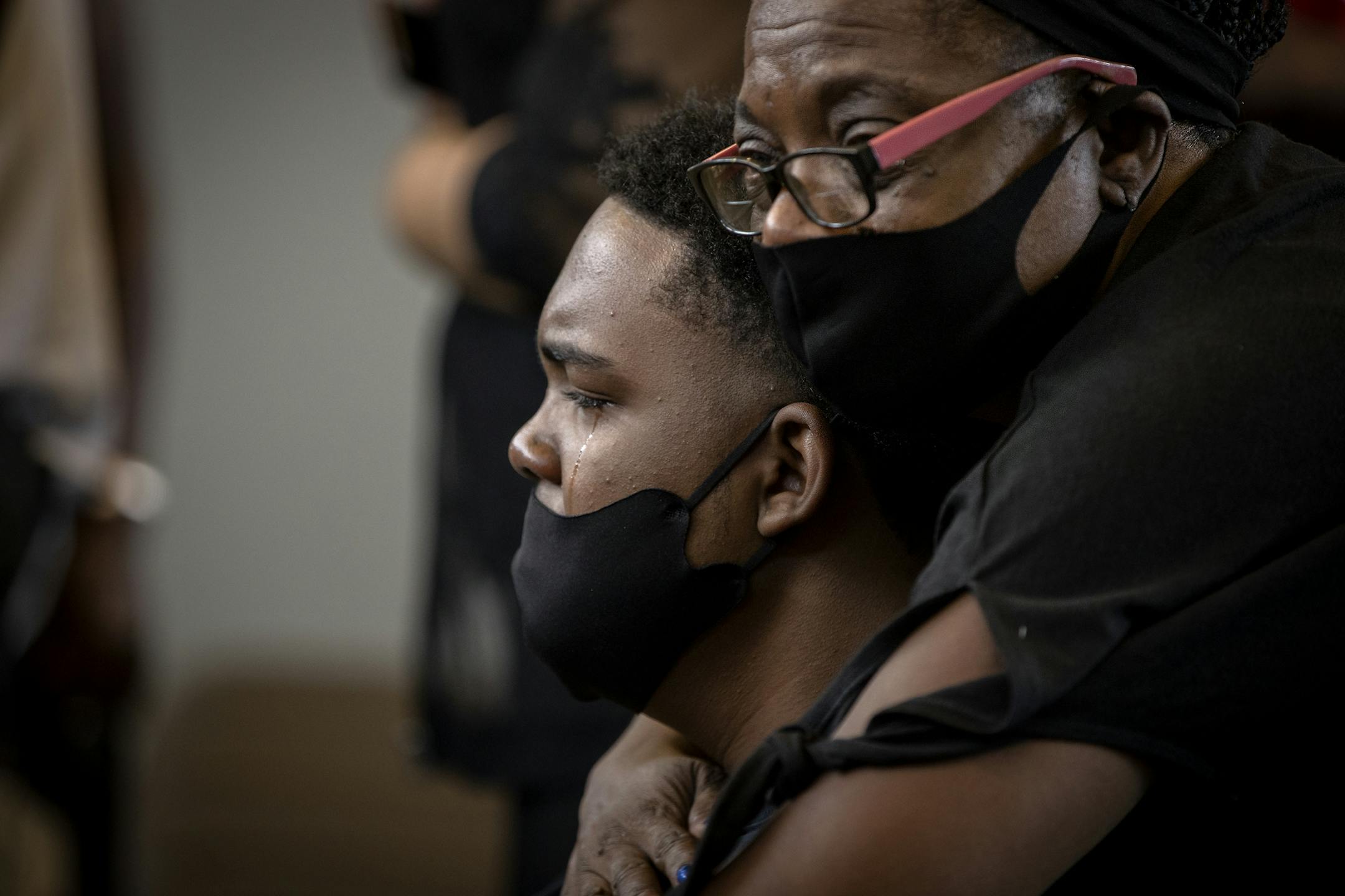 Cavin Horton, the son of Calvin L. Horton Jr. is embraced by Lynn Hopkins during the funeral at Estes Funeral Chapel, Friday, June 19, 2020 in Minneapolis, MN. Horton was shot and killed by John Richard Rieple, a pawn broker. Police found Horton lying on the sidewalk in front of the shop near Bloomington and Lake on the second night of civil unrest in the aftermath of the killing of George Floyd at the hands of Minneapolis police.