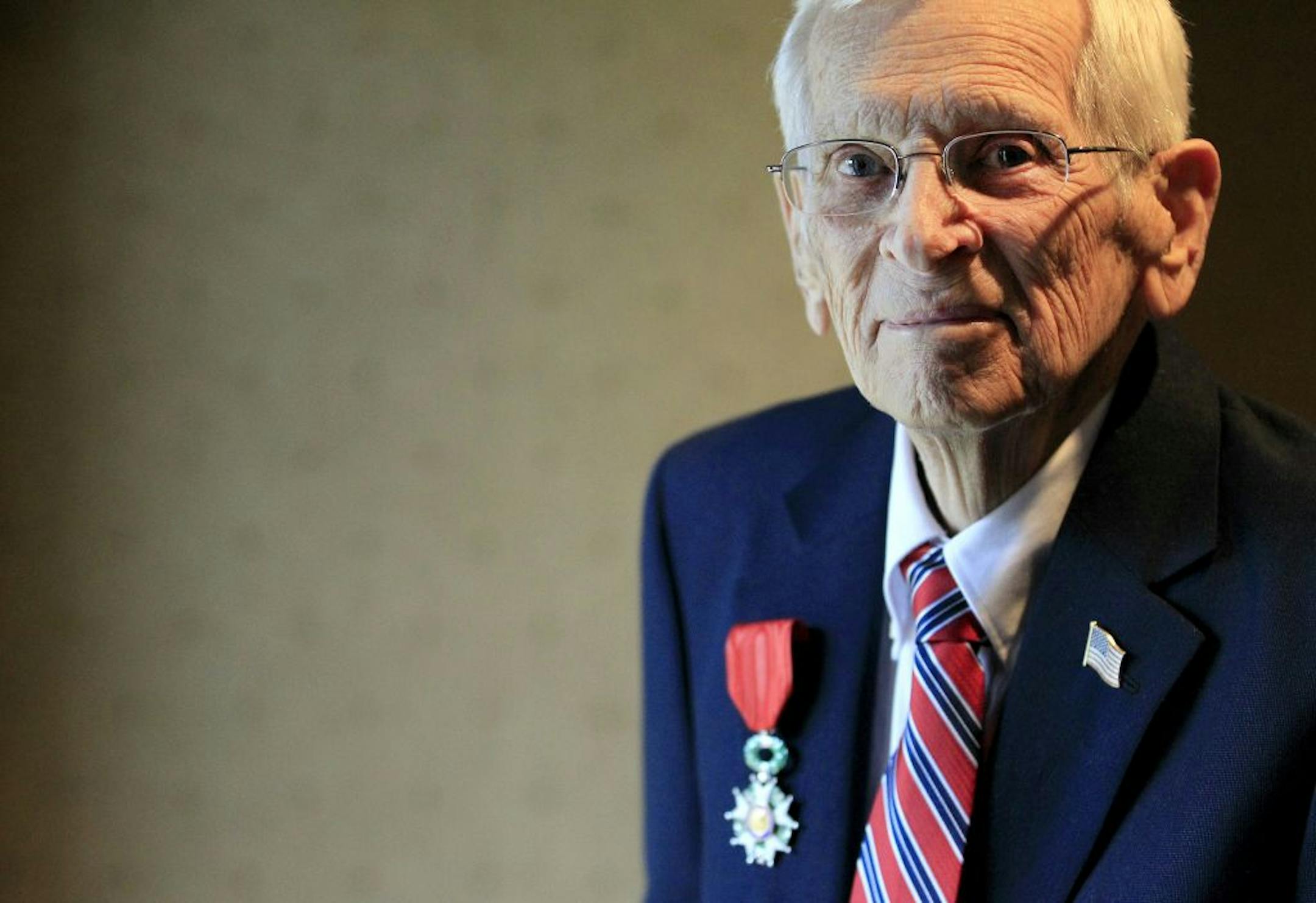 Kenneth Guetzke, 96, a retired lieutenant colonel posed with a Chevalier of the French Legion of Honor that was presented to him for his contributions during World War II.