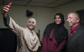 Ayan Abdi left ,and Nimo Ahmed took a photograph with St. Cloud Mayor Dave Kleis during a dinner at his home Tuesday September 19,2017 in St. Cloud, M