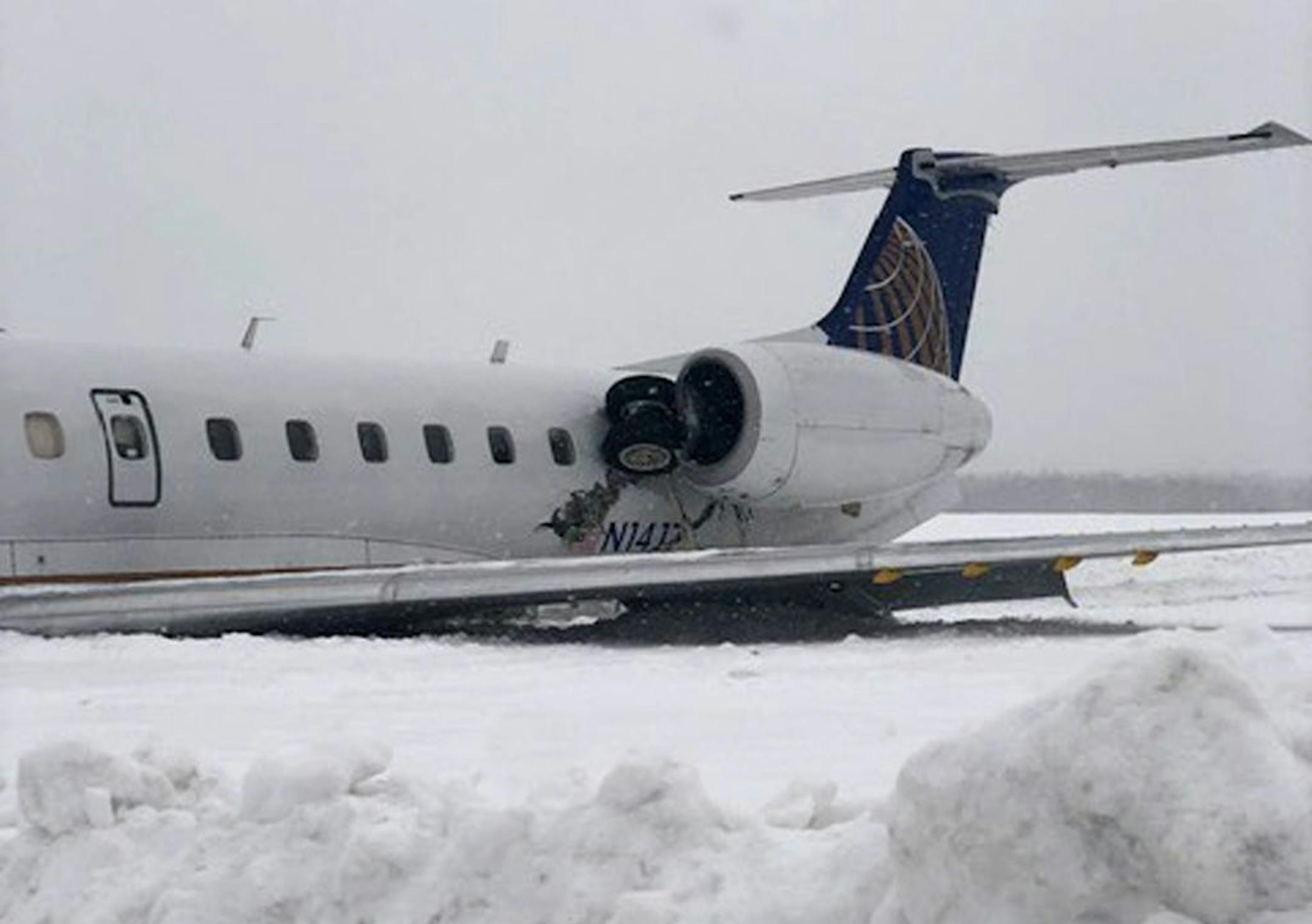 A United Express regional jet that landed during a snow storm is seen where it came to a rest at Presque Isle International Airport on Monday, March 4, 2019, in Presque Isle, Maine.