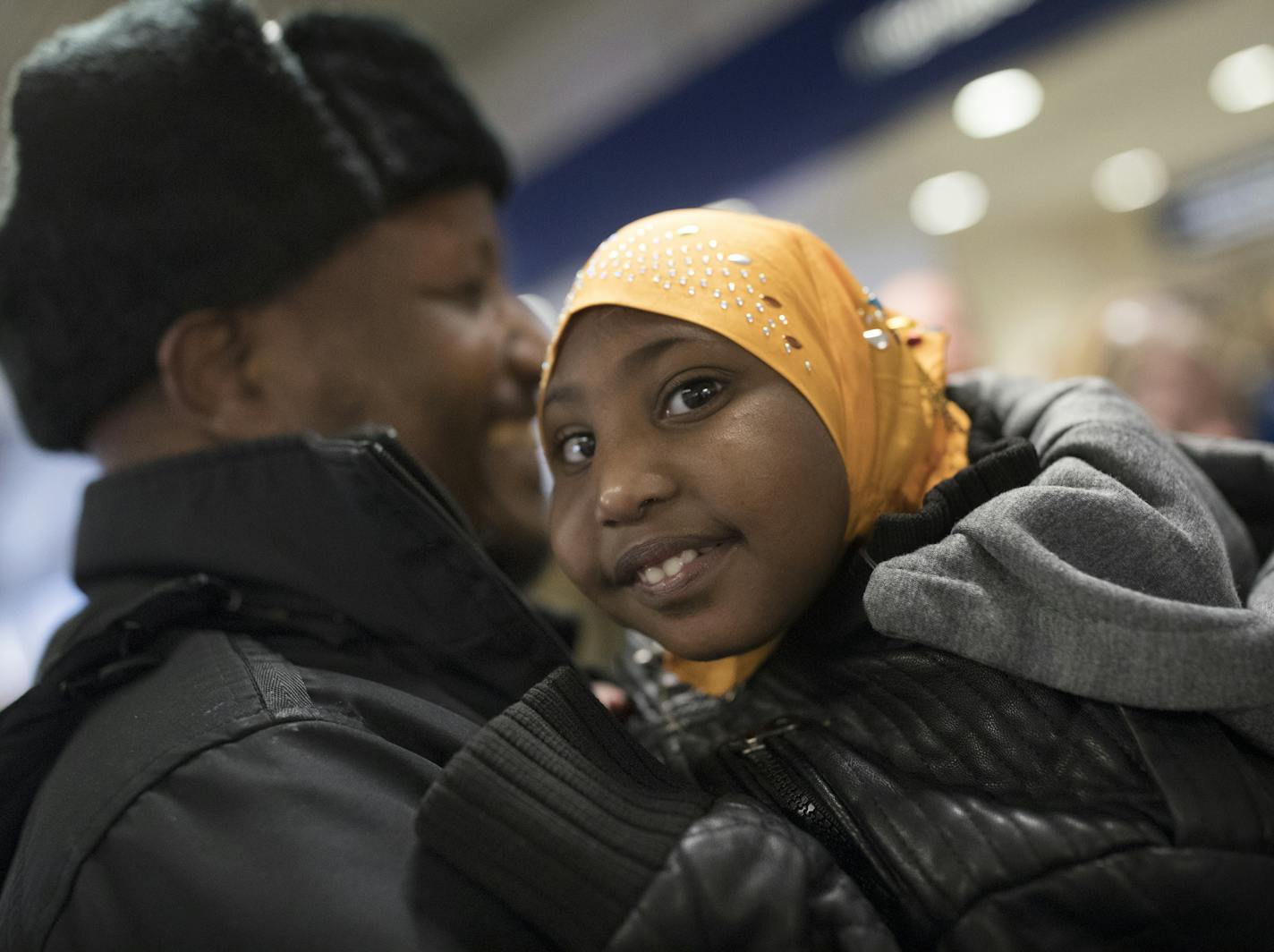 Mohamed lye held his 4-year-old daughter Nimo, as he was reunited with his wife Saido Ahmed Abdille and their other daughter Nafiso, 2, at right at MSP Airport after arriving from Amsterdam Sunday Feb 5, 2017.