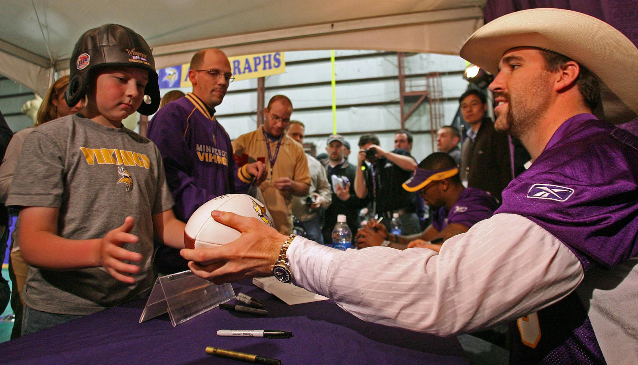 Newly acquired Jared Allen signs autographs for the fans at the Viking party.