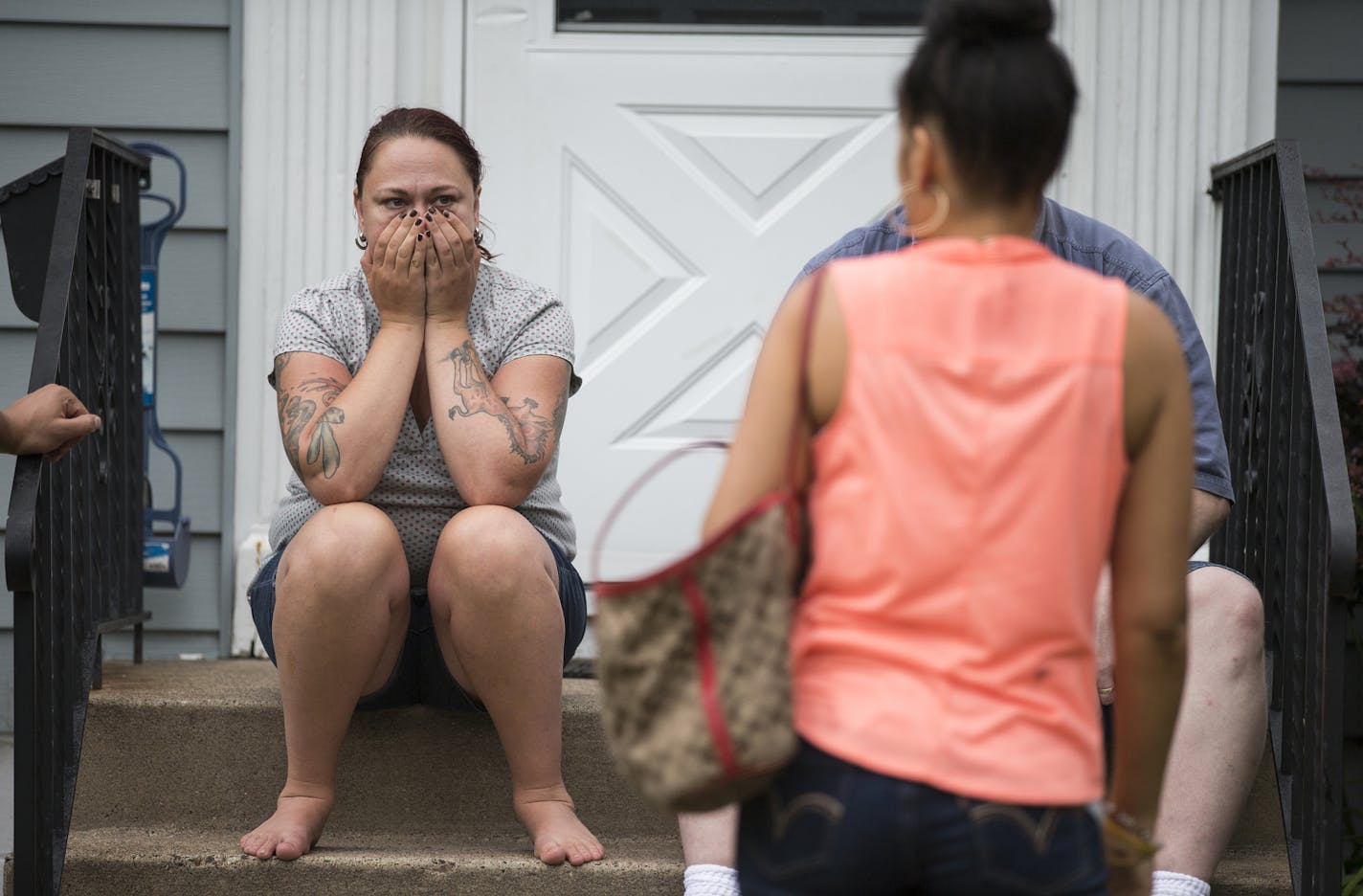 Neighbor Dayna Hudson gathers with other neighbors nearby the possible home invasion and homicide at 5120 DuPont Avenue North in Minneapolis on Thursday, July 16, 2015. ] LEILA NAVIDI leila.navidi@startribune.com / the site of a possible home invasion and homicide at 5120 DuPont Avenue North in Minneapolis on Thursday, July 16, 2015. ] LEILA NAVIDI leila.navidi@startribune.com /