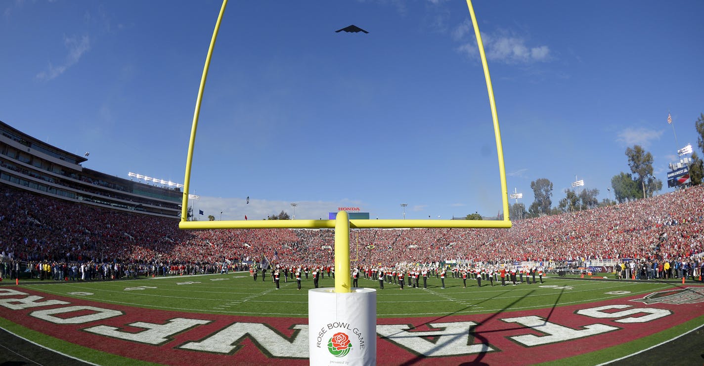 In this image taken with a wide angle lens, a B-2 stealth bomber passes over the stadium during pregame festivities for Rose Bowl NCAA college football game between Stanford and Wisconsin on Tuesday, Jan. 1, 2013, in Pasadena, Calif. (AP Photo/Mark J. Terrill) ORG XMIT: PRB111