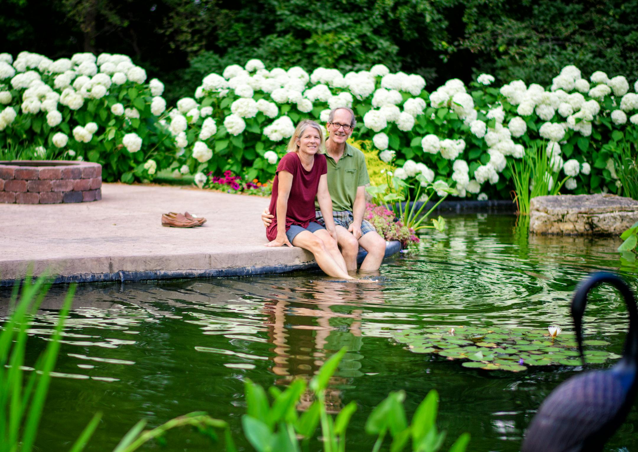 Lisa Moran and Peter Rekow cool their feet in their koi pond.