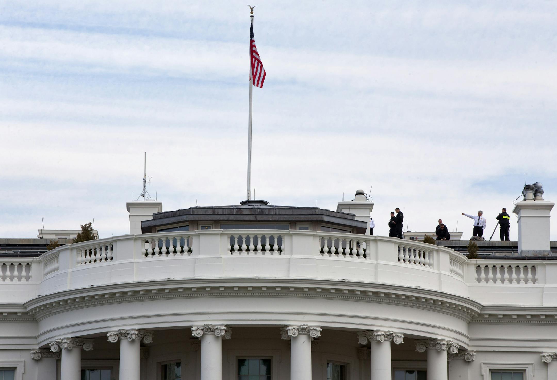 In a view from the South Lawn on Tuesday, Secret Service patrolled the top of the White House.