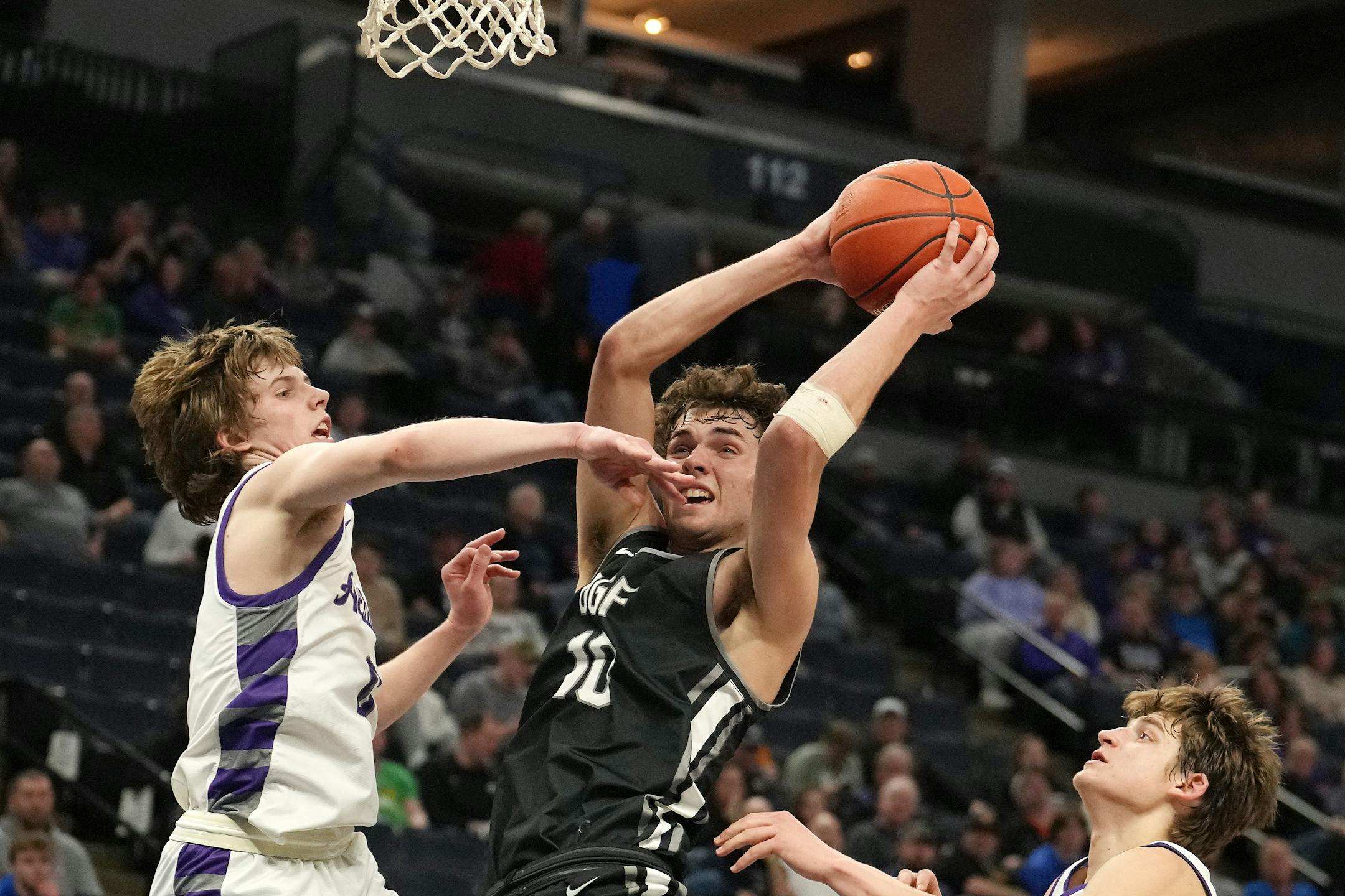 DGF guard Owen Leach (10) grabs a rebound as Albany guard Zeke Austin (0) leaps to defend in the second half.