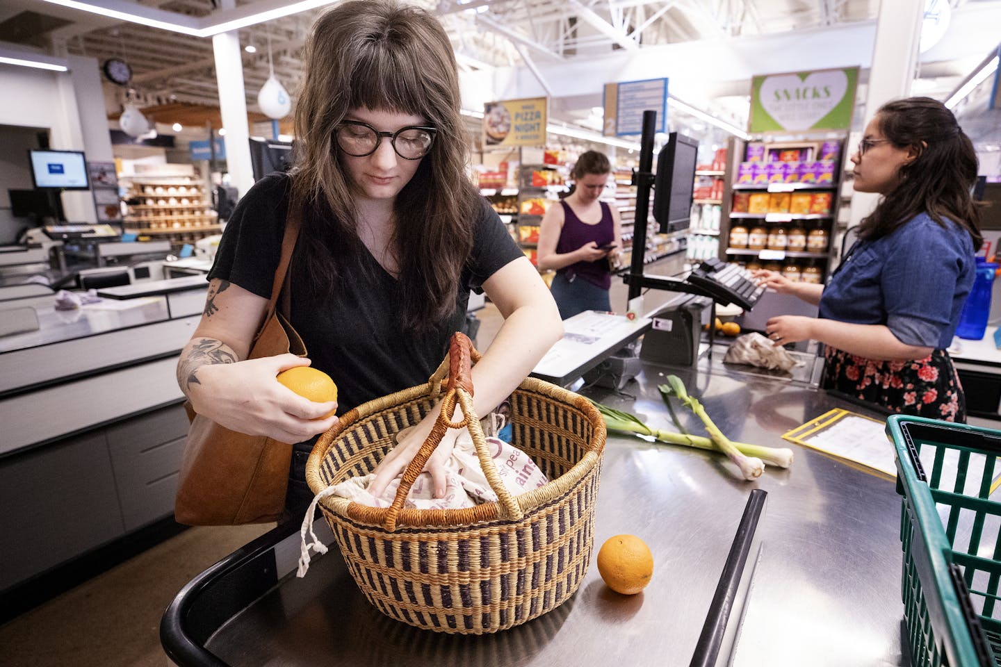 Erika Larson checked out at the Wedge Community Co-op in Minneapolis. Larson is a zero waster. When she shops for food, she buys in bulk, brings a reusable market basket and puts her bulk items into reusable cloth bags. ] CARLOS GONZALEZ • cgonzalez@startribune.com – April 25, 2018, Minneapolis, MN, More Twin Cities families are joining the zero waste movement, working to drastically reduce the amount of garbage they add to our landfills. Erika Larson is a zero waster. When she shops for food, s