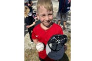 Calvin Moehrle, an 8-year-old from Minneapolis, showed off his autographed Twins cap and Royce Lewis-signed ball outside Hammond Stadium in Fort Myers