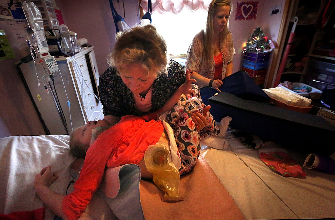 RN Patty Tice moved ten-year-old Morgan Sawyer into position as she prepared to transfer the child to a wheelchair. At right is Morgan&#xed;s mother, Heather Sawyer. ] JIM GEHRZ &#xef; james.gehrz@startribune.com / Belle Plain, MN / February 24, 2016 /9:00 AM &#xf1; BACKGROUND INFORMATION: A severe shortage of caregivers is forcing families across the state to go to extreme lengths to care for their loved ones. In some cases, families are being forced to rely on their children, or their elderly