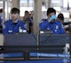 Transportation Security Administration officers work at a checkpoint at O'Hare airport in Chicago, Saturday, Jan. 5, 2019. The TSA acknowledged an inc