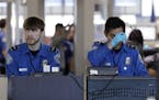 Transportation Security Administration officers work at a checkpoint at O'Hare airport in Chicago, Saturday, Jan. 5, 2019. The TSA acknowledged an inc