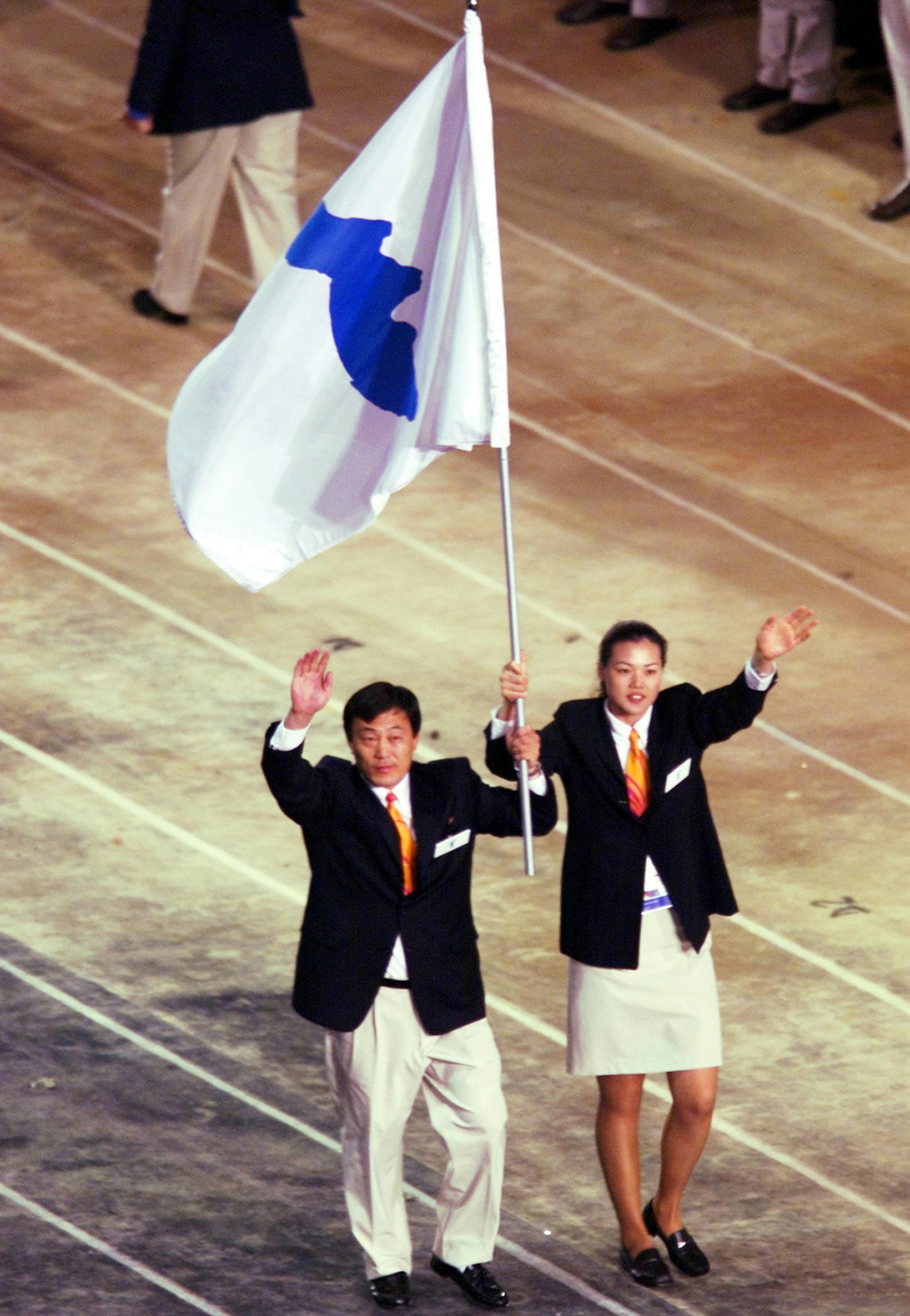 FILE - In this Sept. 15, 2000, file photo, Pak Jung Chul, left, a North Korea's Judo coach, and Chung Eun-sun, a South Korean basketball player, carry a flag representing a united Korea into Olympic Stadium during the Opening Ceremony of the Olympics in Sydney. When athletes of the rival Koreas walked together behind a single flag for the first time since their 1945 division at the start of the Sydney Olympics, it was a highly emotional event that came on the wave of reconciliation mood followin