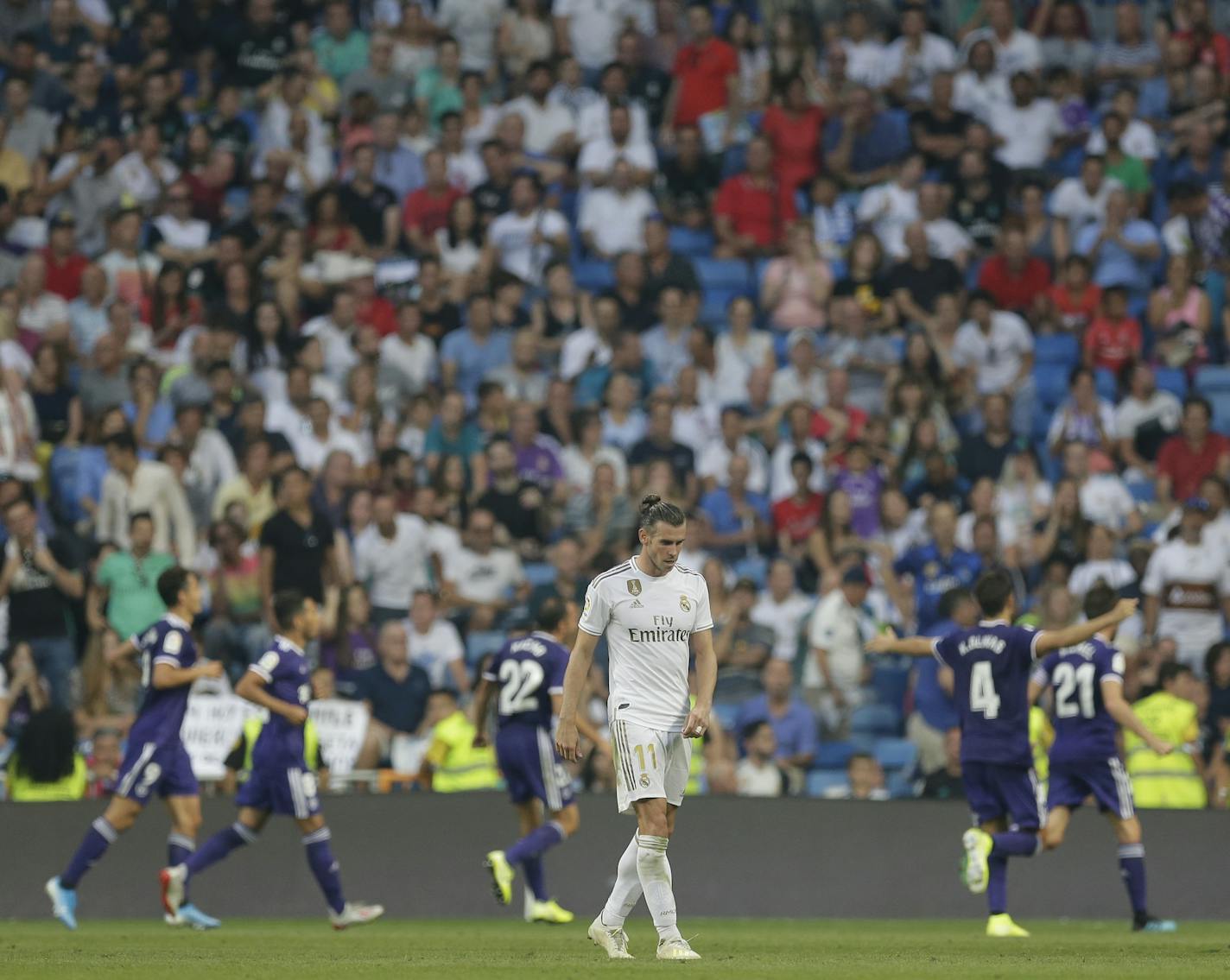 Real Madrid's Gareth Bale reacts as Valladolid's Sergi Guardiola celebrates after scoring his side's first goal during a Spanish La Liga match between Real Madrid and Valladolid on Aug. 24 in Madrid.