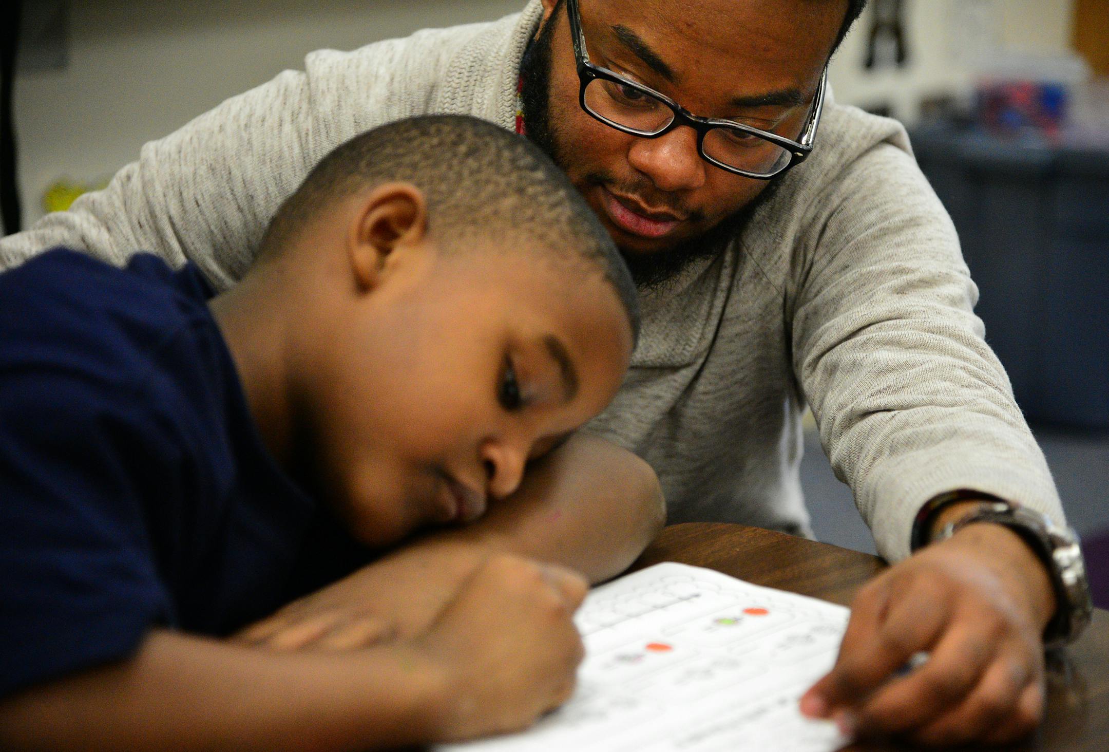 Jayden Myles is a navigator which is like a mentor who works with students in the NAZ program. He works with these young scholars one on one focusing on strengths and weaknesses of students while building esteem and improving academic outcomes. He was working on math skills with Rayshawn Kidd during an after school program ] Nellie Stone Johnson Community School is in the Northside Achievement Zone. Richard.Sennott@startribune.com Richard Sennott/Star Tribune Minneapolis , Minn.Wednesday 3/26/20