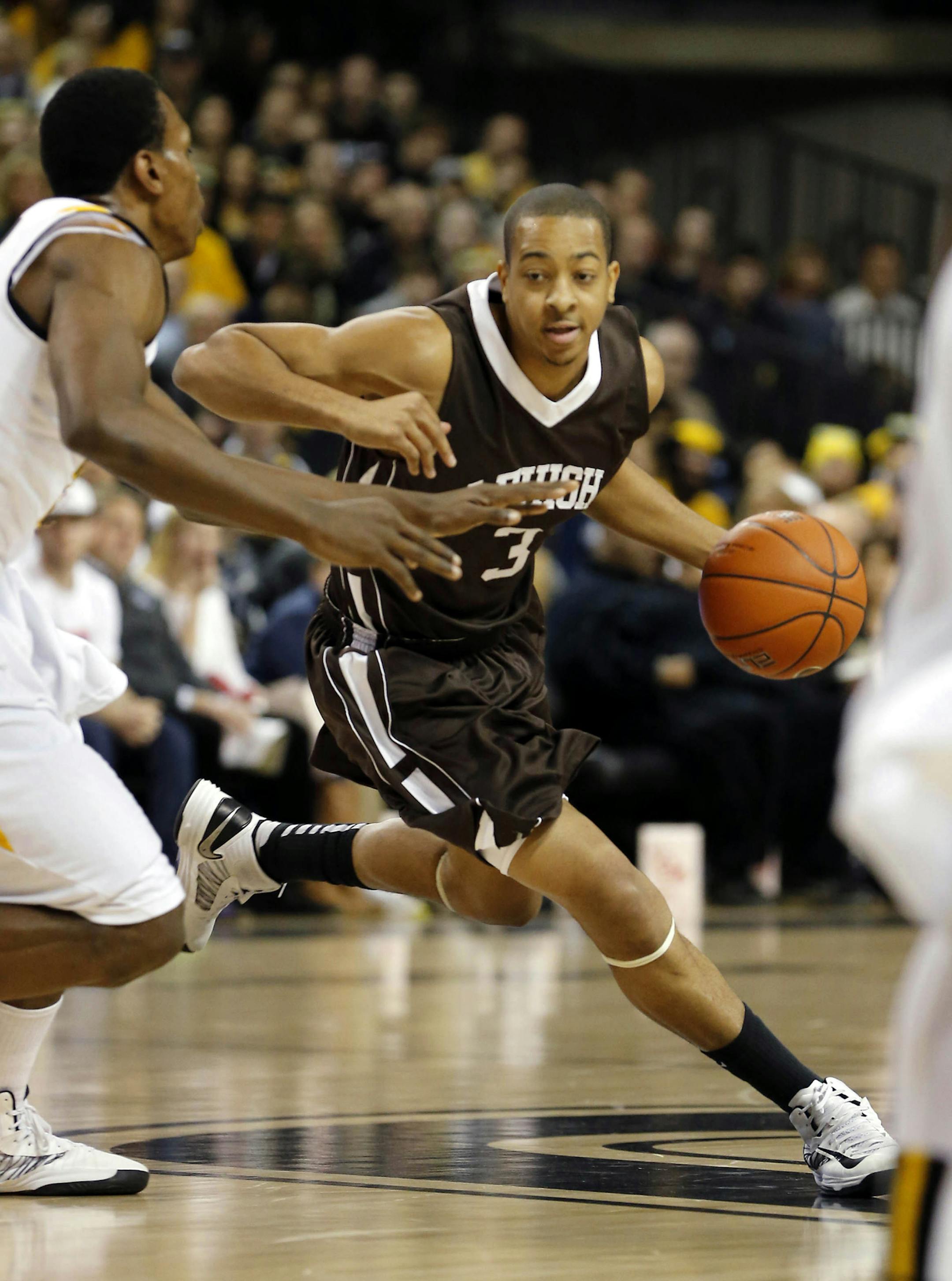 Lehigh's C.J.McCollum tries to get around a VCU defender during first half of an NCAA college basketball game in Richmond, Va., Sat. Jan 5, 2013. (AP Photo/The Richmond Times-Dispatch, Joe Mahoney) ORG XMIT: VARIT101