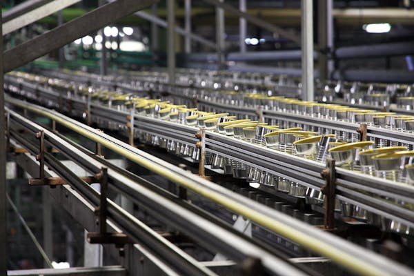 Cans travel down an assembly line at a Seneca Foods plant.