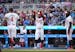 Twins outfielder Byron Buxton raises his hands to celebrate with shortstop Carlos Correa (4) as he crosses home plate in the first inning after a two-