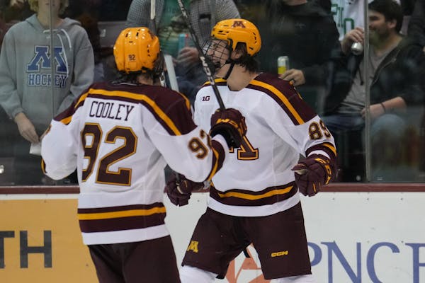 The Gophers Matthew Knies (89) celebrated with Logan Cooley after scoring against North Dakota on Saturday night, Oct. 22, 2022, at 3M Arena at Mariuc
