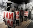In a museum exhibit detailing the 1968 strike by Memphis garbagemen, models of the sanitation workers hold placards that read "I Am a Man," the battle