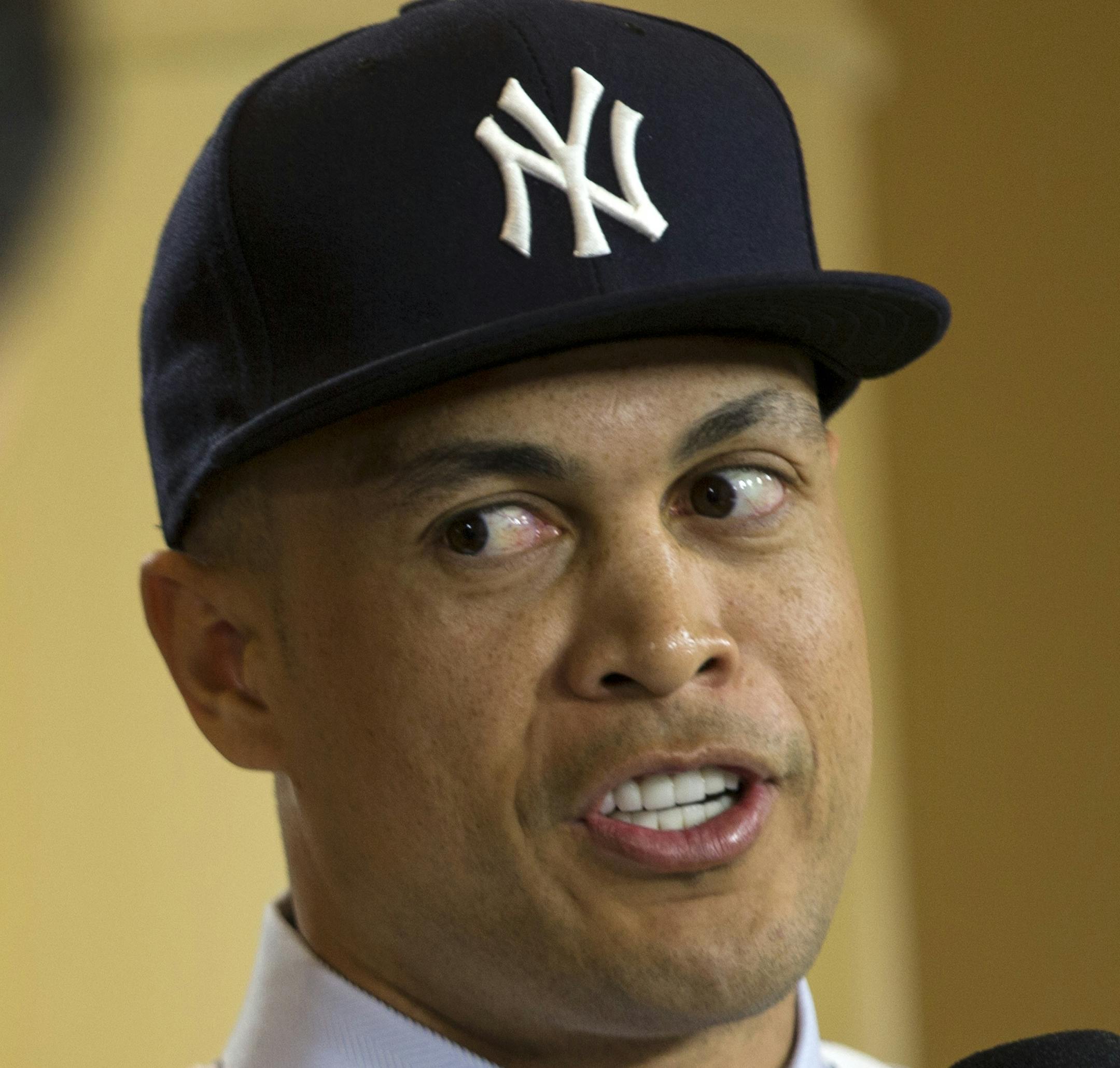 New Yankee Giancarlo Stanton talks with reporters on set during the Major League Baseball winter meetings in Orlando, Fla., Monday, Dec. 11, 2017. (AP Photo/Willie J. Allen Jr.)
