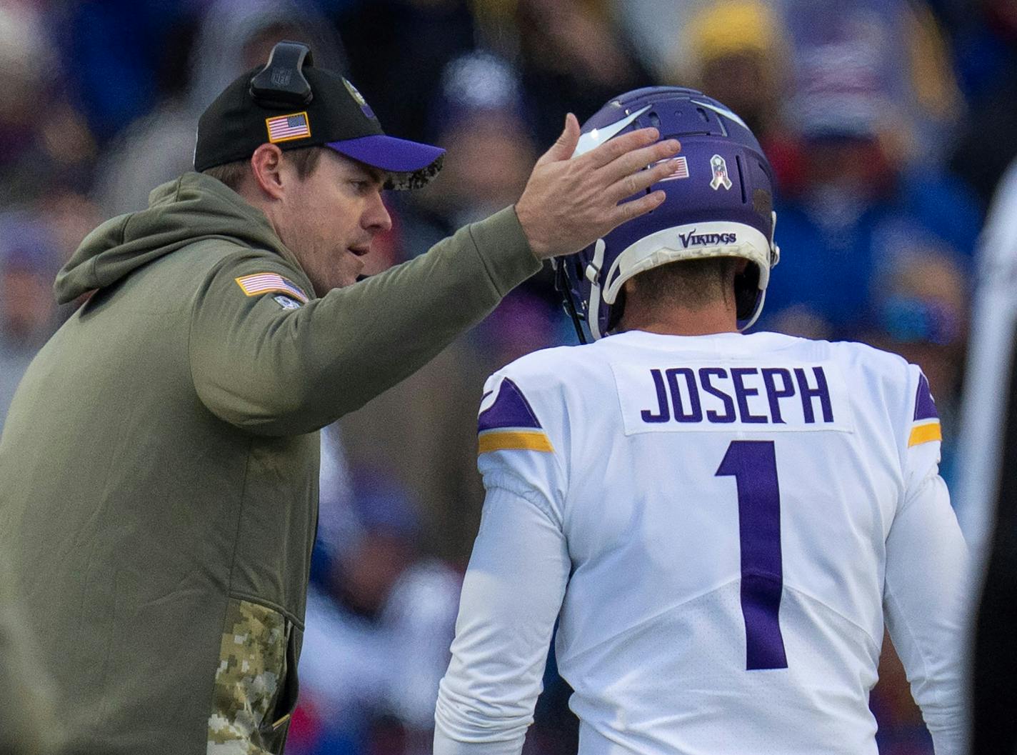 Minnesota Vikings head coach Kevin O'Connell, pats Minnesota Vikings place kicker Greg Joseph (1) on the helmet after he missed a 4th quarter extra point in Orchard Park.,N.Y.Sunday November 13, 2022.