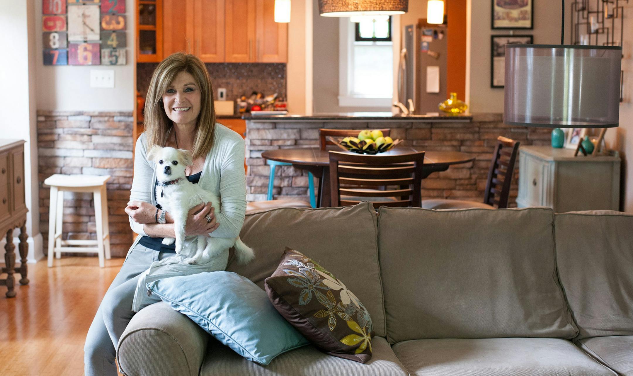 Karen DeJeet sits for a portrait in her Sears kit house on Monday, Aug. 21, 2017 in Forest Hills, Pa. DeJeet has developed a passion for the Sears homes, which she tracks and researches all over Southwestern Pennsylvania. (Stephanie Strasburg/Pittsburgh Post-Gazette/TNS)